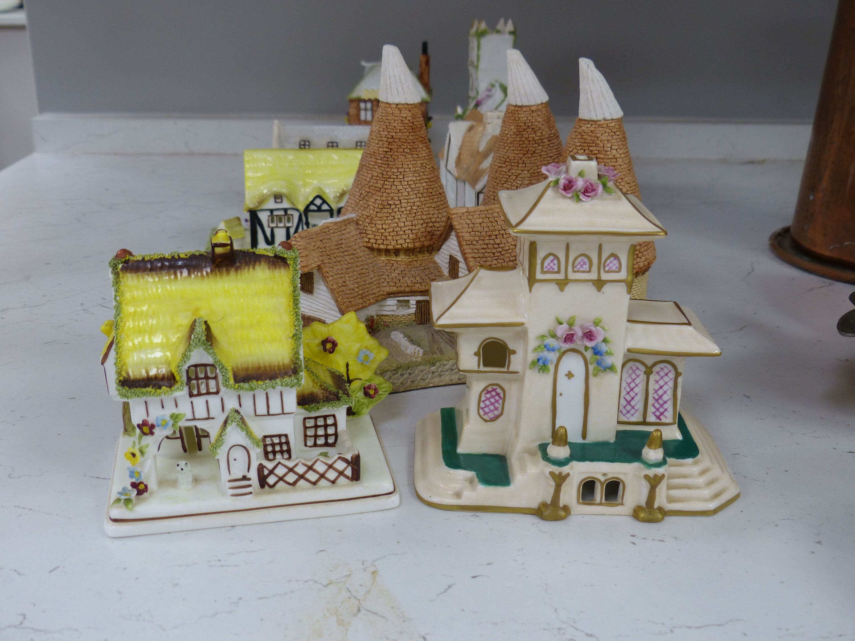 Seven Coalport bone china 'cottage' pastille burners and four similar resin examples (11)